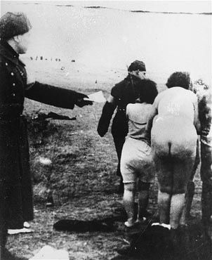 A Latvian policeman leads a group of Jewish women to the execution site in Latvia